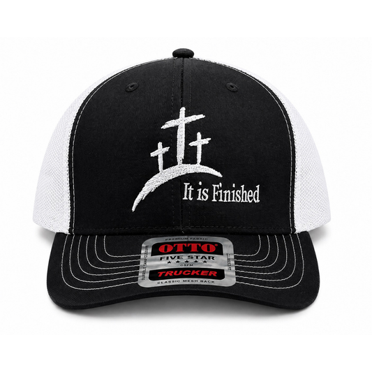 A black and white trucker cap featuring three white crosses on a hill with the text 'It is Finished' embroidered on the front. The brim has a silver metal size sticker for an Otto Five Star 5-7/8 trucker fit.